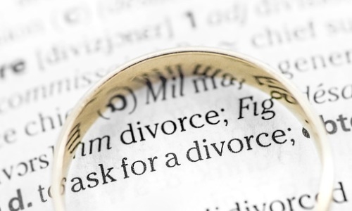 divorce paperwork with gold ring on top
