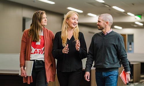 "Anna Carpenter walking and speaking with students"