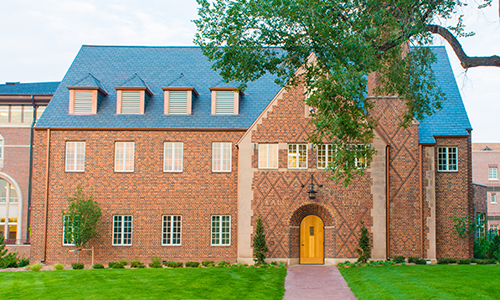 "exterior of two-story brick building with blue roof"