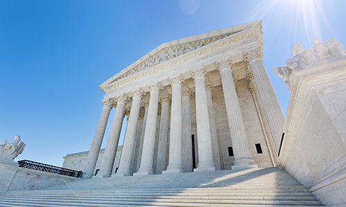 "exterior of U.S. Supreme Court building on sunny day"