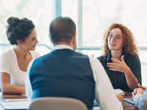 people talking together around a table
