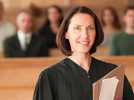A judge holding papers in her courtroom