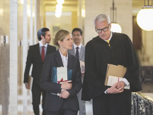 A judge walking and talking with colleagues