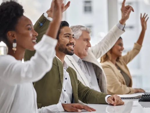 People raising their hands to participate together