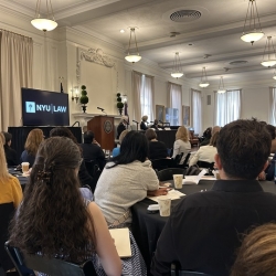 A panel giving a presentation to a crowd