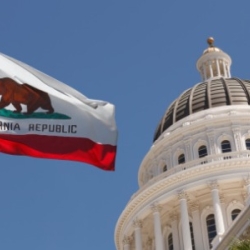 California state capitol building with state flag flying in front