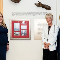 IAALS founders and CEO standing beside new tribute wall