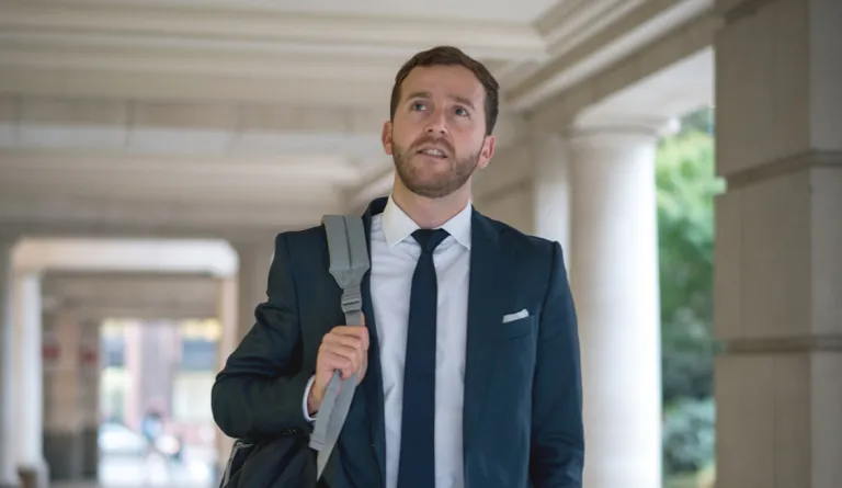 A law student walking through a school entryway