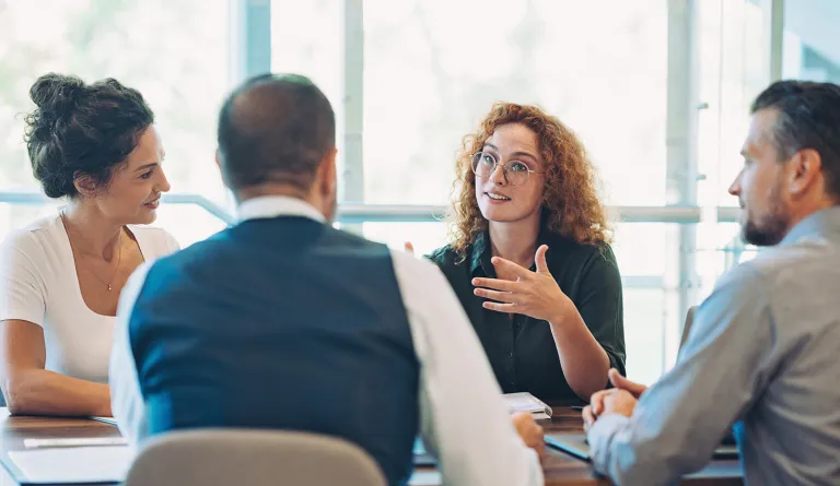 people talking together around a table