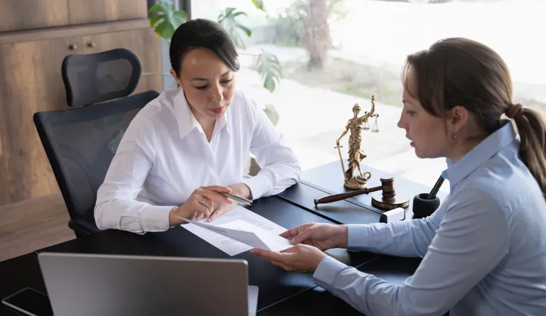 Judge talking with colleague and reviewing paperwork