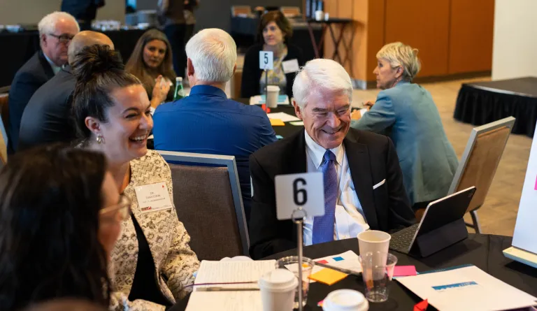 A group of people sitting at a table. 