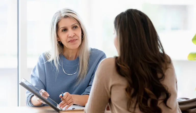 Lawyer showing her client a tablet