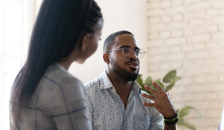 A man speaking with a small group of people