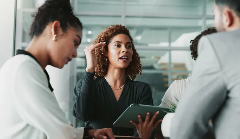 Woman speaking with her research team