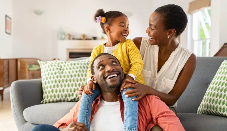 A family of three smiling together