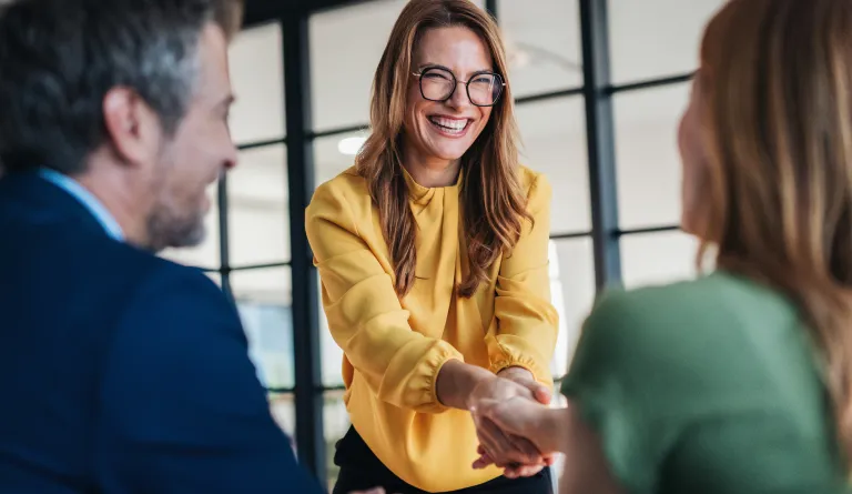 A lawyer shaking their client's hand