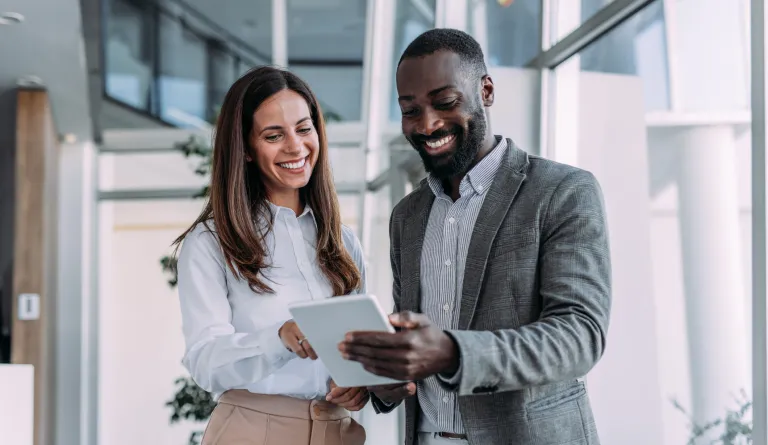 Two people using a tablet