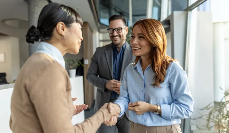 Three people shaking hands