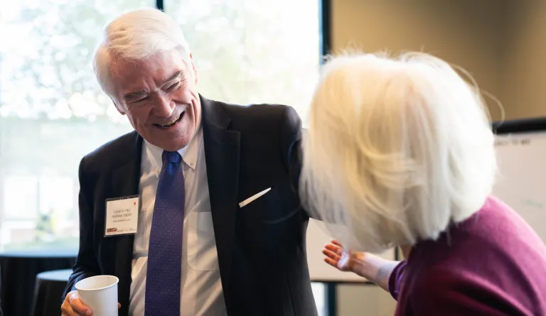 Chief Justice Nathan L. Hecht (Ret.) giving someone a hug