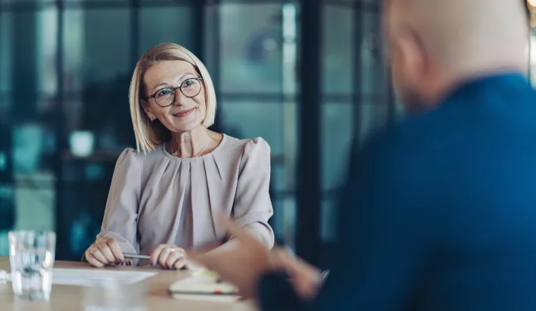 A woman listens to someone talking to her
