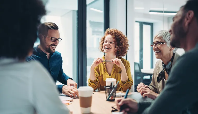 A group of researchers laughing together. 