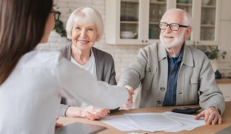 A lawyer helping an elderly couple with paperwork.