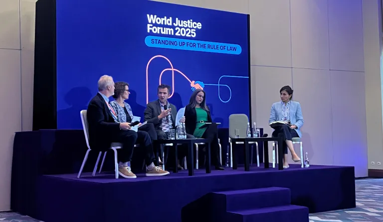 People talking onstage at a panel at the World Justice Forum 2025