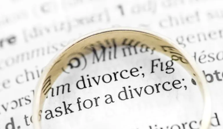 divorce paperwork with gold ring on top