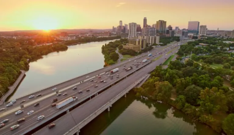 bridge over river at sunset