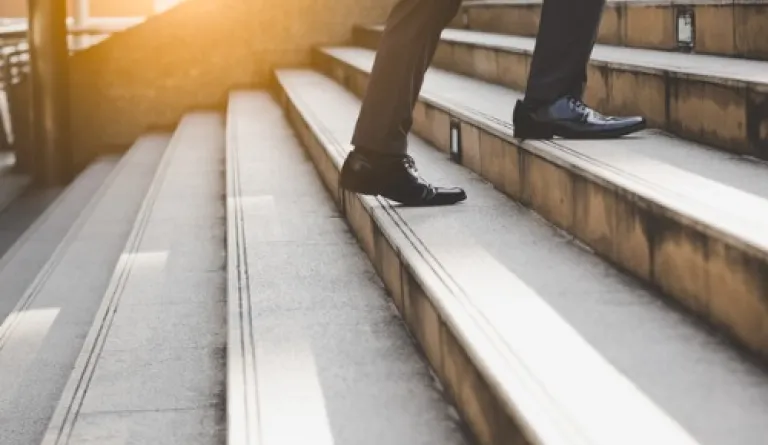legs walking up concrete stairs