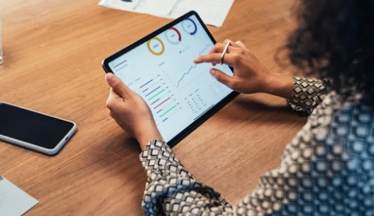 businesswoman analyzing data on tablet