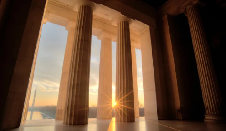 View from inside a courthouse looking out during a sunrise
