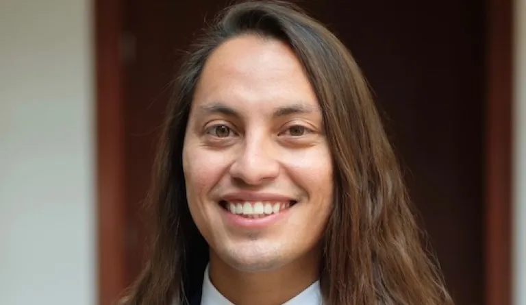 headshot of long-haired man