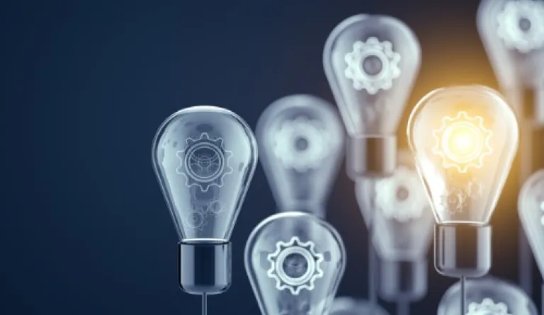 group of lightbulbs with one lit up