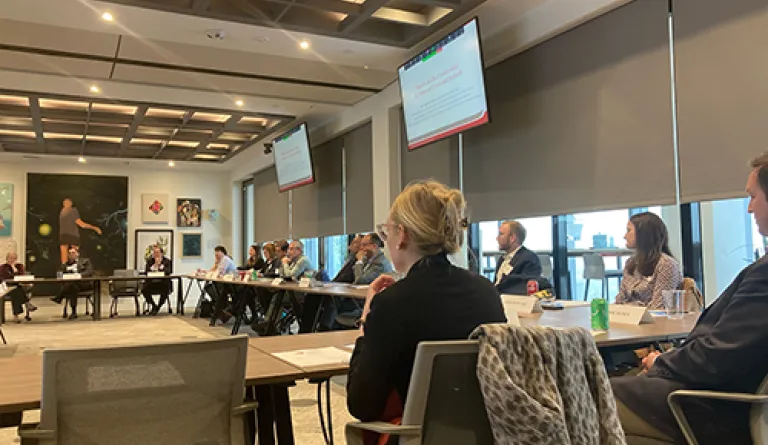 people in conference room watching presentation