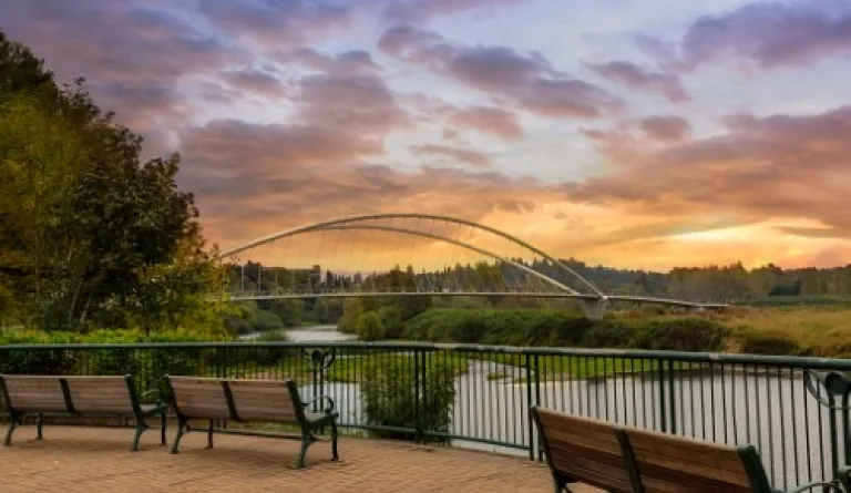 park benches on riverfront at sunset