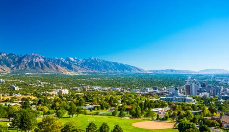 aerial view of city on sunny day with mountains in the background