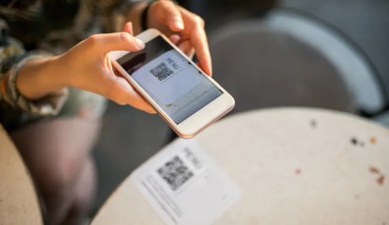 woman scanning QR code with smartphone