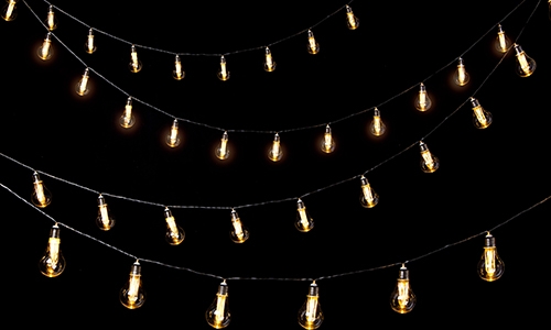 strings of lightbulbs on black background