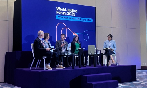 People talking onstage at a panel at the World Justice Forum 2025