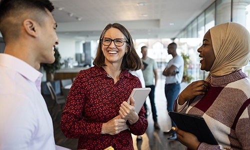 three people at work smiling