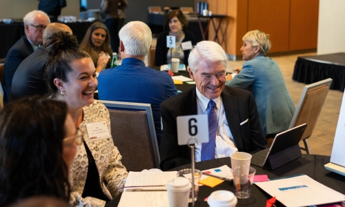 A group of people sitting at a table.