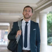 A law student walking through a school entryway