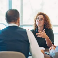 people talking together around a table