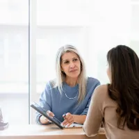 Lawyer showing her client a tablet
