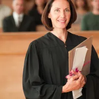 A judge holding papers in her courtroom