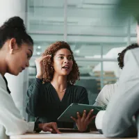 Woman speaking with her research team