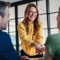 A lawyer shaking their client's hand