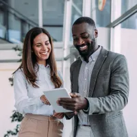 Two people using a tablet