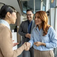 Three people shaking hands